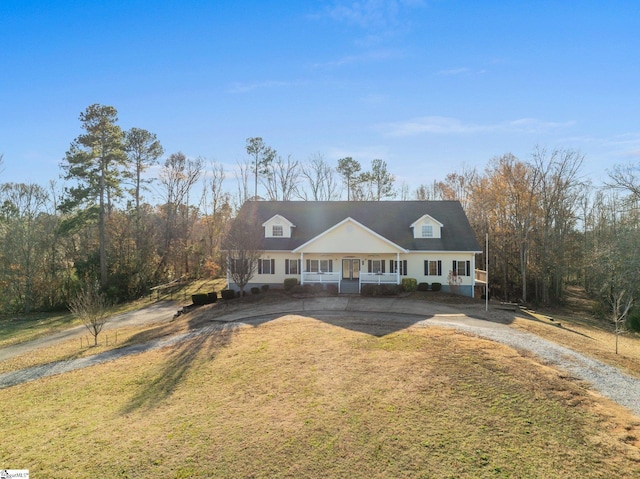 new england style home with covered porch and a front yard