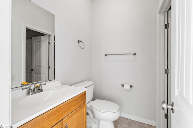 bathroom with tile patterned floors, vanity, and toilet