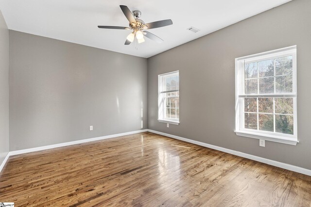 unfurnished room with ceiling fan and wood-type flooring