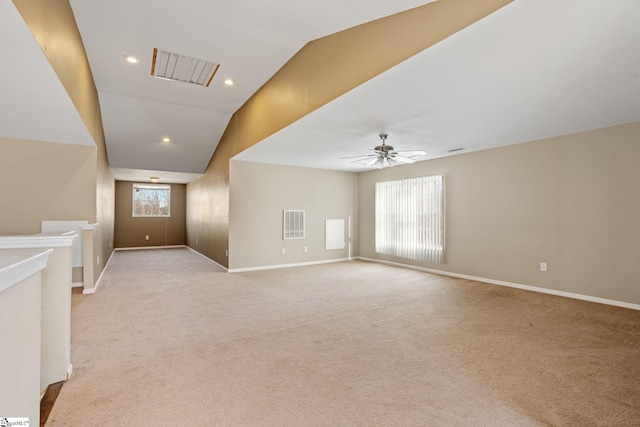 interior space with light carpet, vaulted ceiling, and ceiling fan