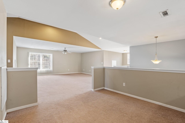 spare room with light colored carpet, ceiling fan, and lofted ceiling