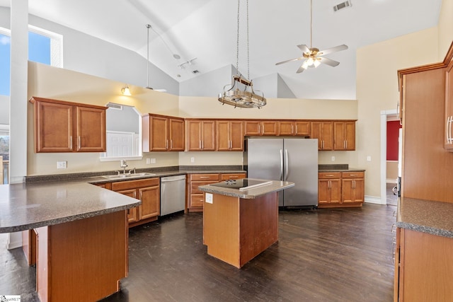 kitchen featuring a center island, high vaulted ceiling, stainless steel appliances, and sink