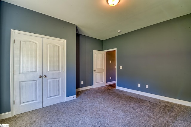 unfurnished bedroom featuring a closet and carpet floors