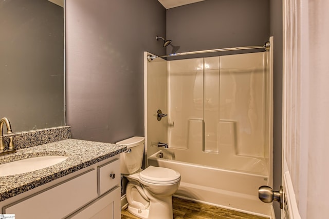 full bathroom featuring hardwood / wood-style flooring, vanity, toilet, and shower / tub combination