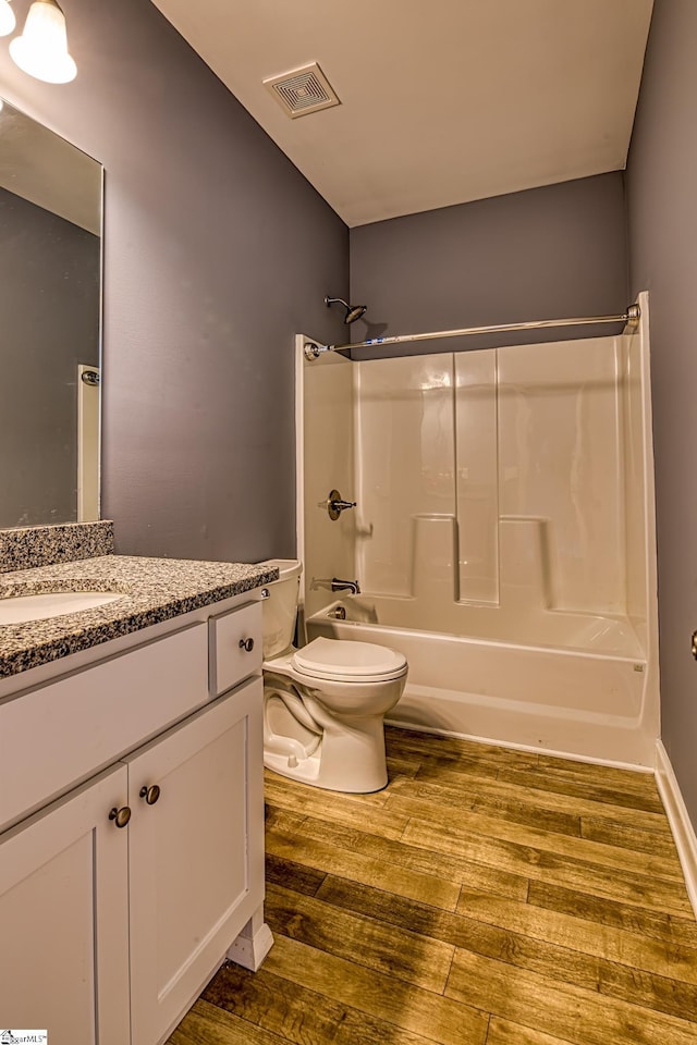 full bathroom featuring bathing tub / shower combination, vanity, wood-type flooring, and toilet