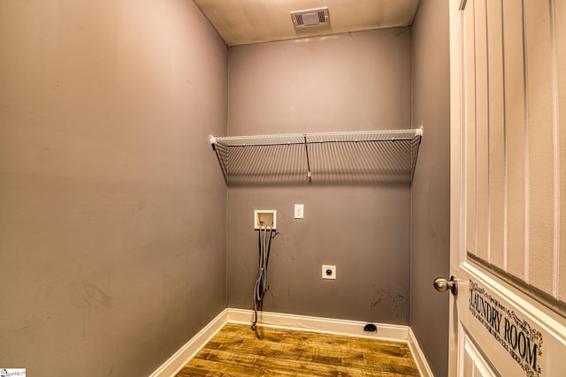 washroom with electric dryer hookup, hardwood / wood-style floors, and washer hookup