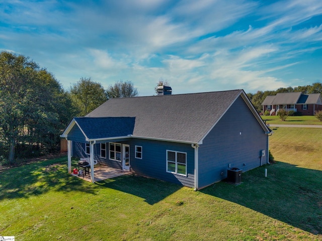 back of house with a lawn, cooling unit, and a patio area