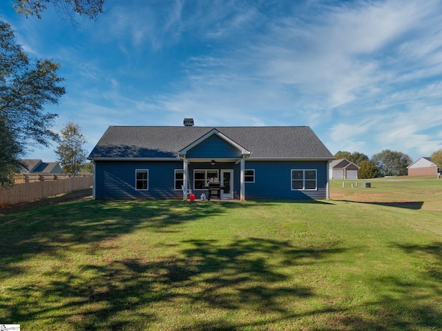 back of house with a yard and ceiling fan