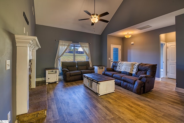 living room with ceiling fan, dark wood-type flooring, and high vaulted ceiling