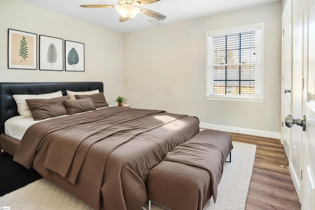 bedroom with hardwood / wood-style floors and ceiling fan