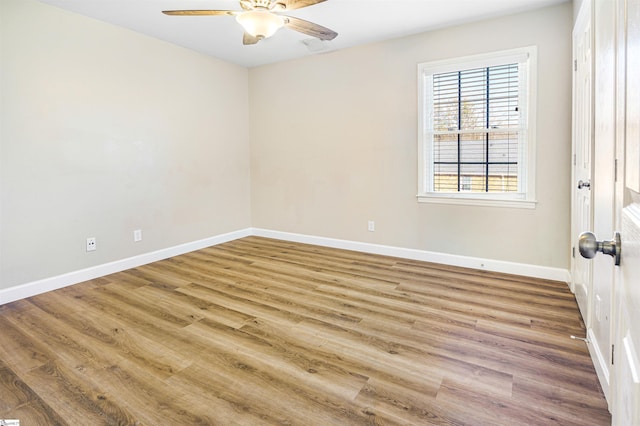 empty room with ceiling fan and light wood-type flooring