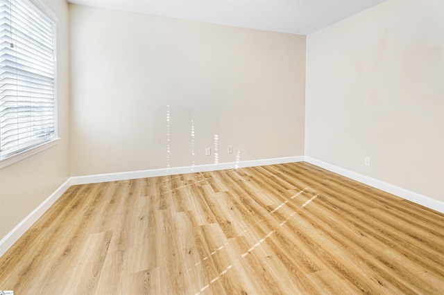 unfurnished room featuring light hardwood / wood-style flooring and plenty of natural light