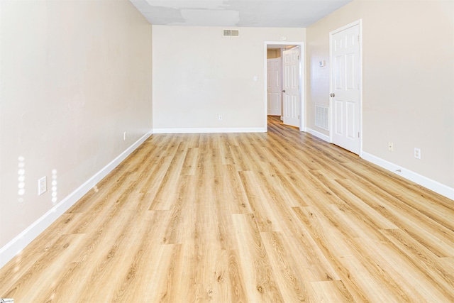 spare room featuring light wood-type flooring