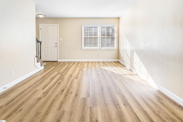 unfurnished room with light hardwood / wood-style flooring