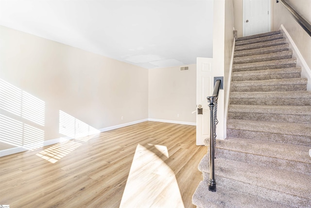 stairs with hardwood / wood-style floors