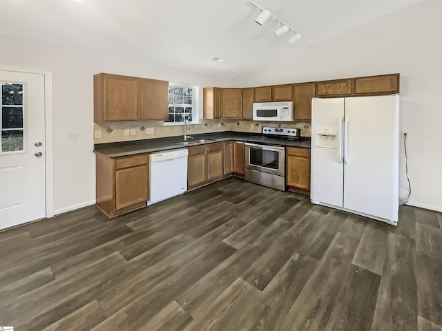 kitchen with white appliances, sink, a wealth of natural light, and track lighting