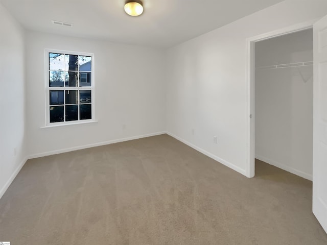 unfurnished bedroom with carpet and a closet