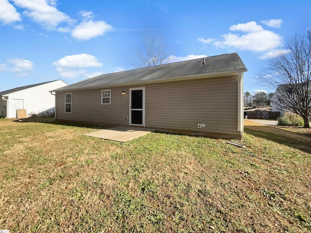 back of house with a patio area and a lawn