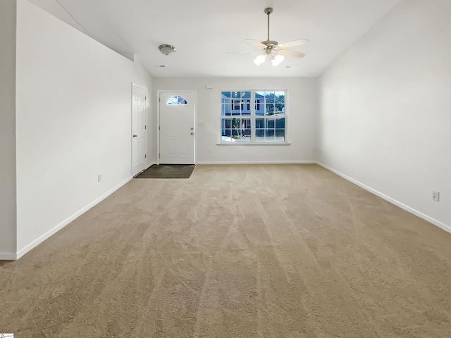 interior space featuring carpet floors and ceiling fan