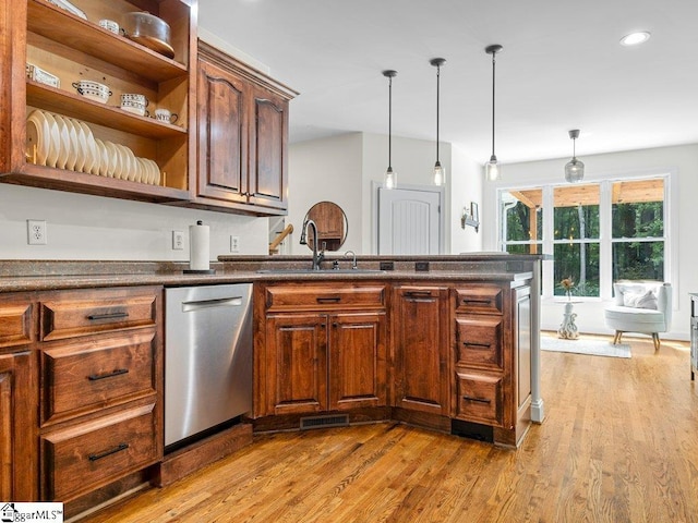 kitchen with dishwasher, decorative light fixtures, light hardwood / wood-style floors, and sink