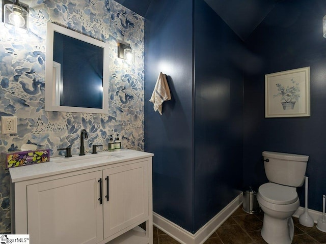 bathroom with tile patterned flooring, vanity, and toilet