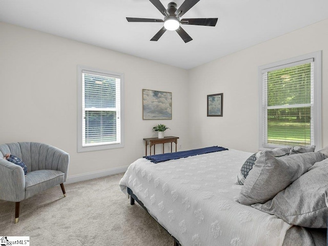 bedroom featuring light colored carpet and ceiling fan