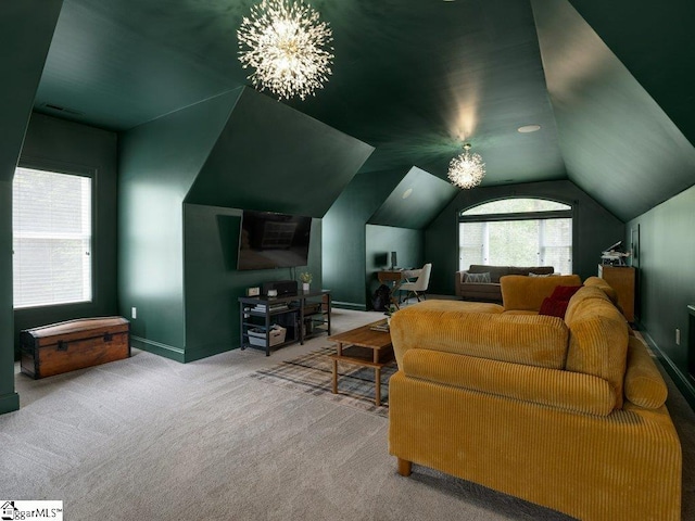 carpeted home theater featuring a notable chandelier and lofted ceiling