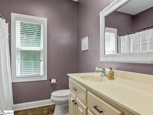 bathroom with tile patterned flooring, vanity, and toilet