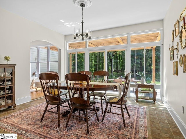 dining area with a healthy amount of sunlight and a chandelier