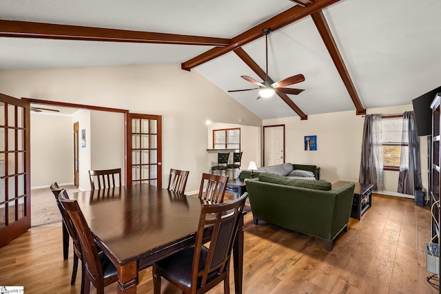 dining area with light wood-type flooring, french doors, lofted ceiling with beams, and ceiling fan