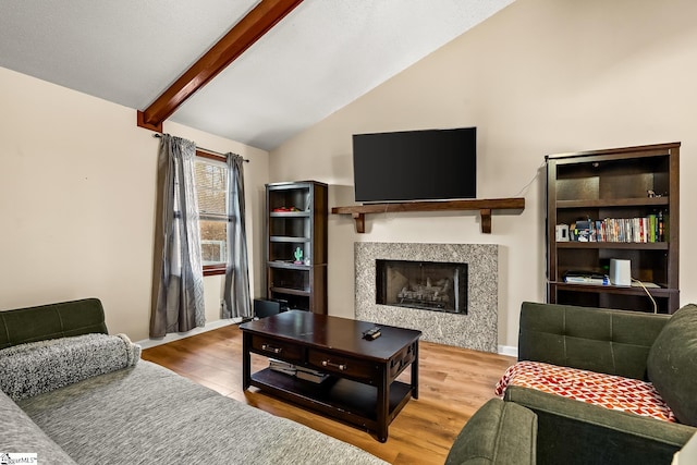 living room featuring vaulted ceiling with beams and hardwood / wood-style floors