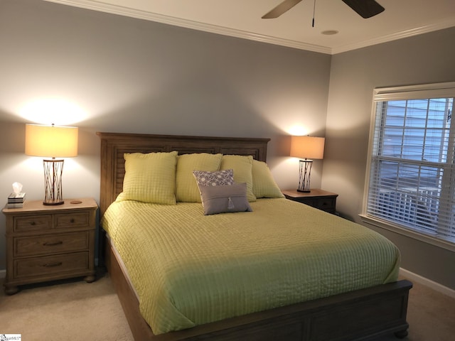 carpeted bedroom with ceiling fan and crown molding