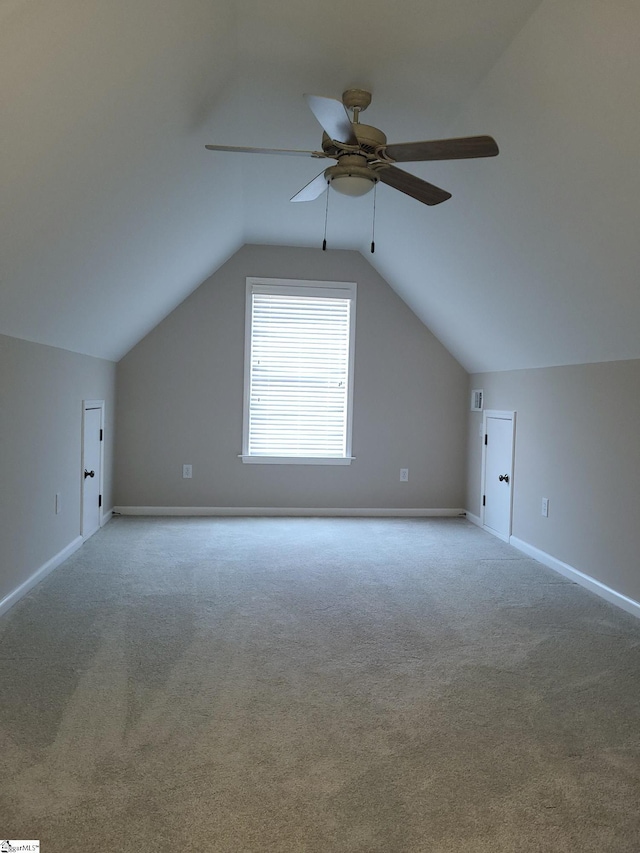 additional living space featuring ceiling fan, light carpet, and lofted ceiling