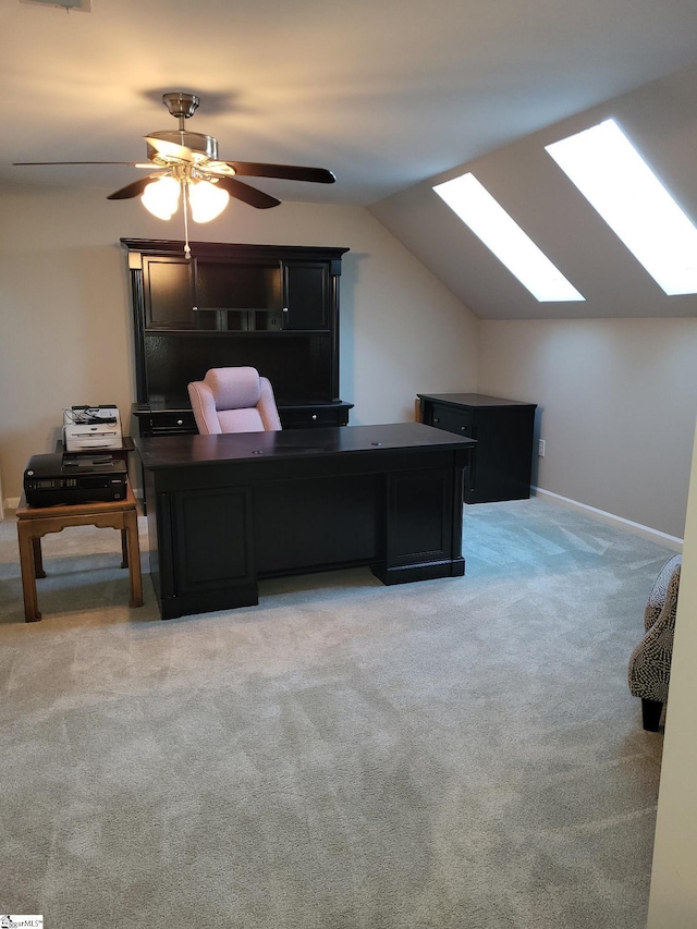 office space featuring carpet, ceiling fan, and lofted ceiling with skylight