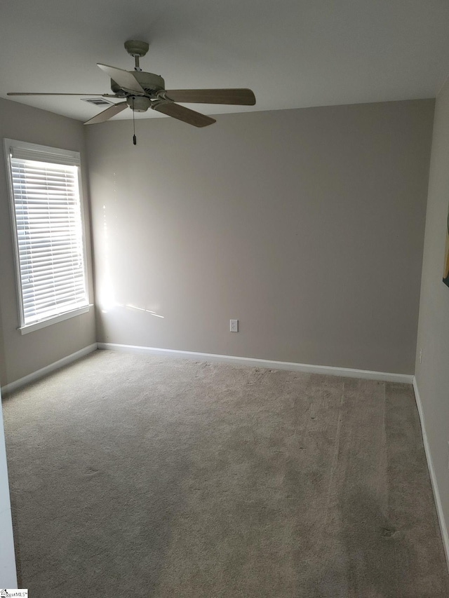 carpeted empty room with ceiling fan