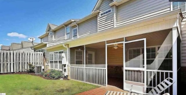 view of property exterior with a lawn and a sunroom