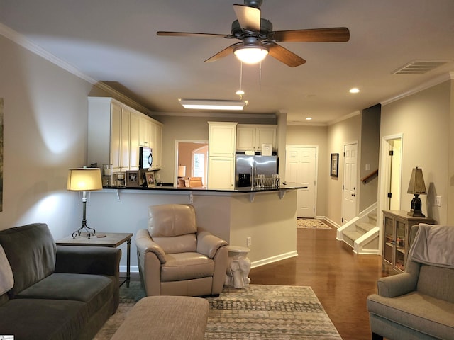 living room with ceiling fan, dark wood-type flooring, and ornamental molding