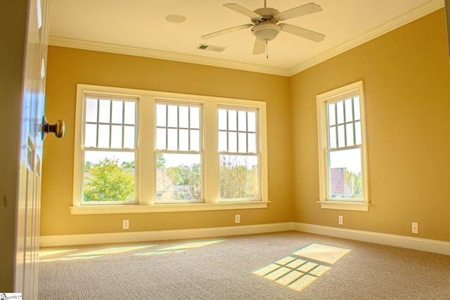 unfurnished room with a wealth of natural light, light carpet, crown molding, and ceiling fan