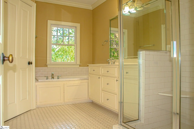 bathroom with ornamental molding, vanity, and independent shower and bath