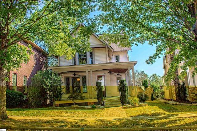 view of front facade featuring covered porch, a front lawn, and ceiling fan