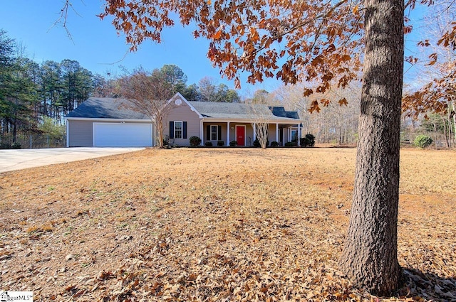 single story home with covered porch, a front yard, and a garage