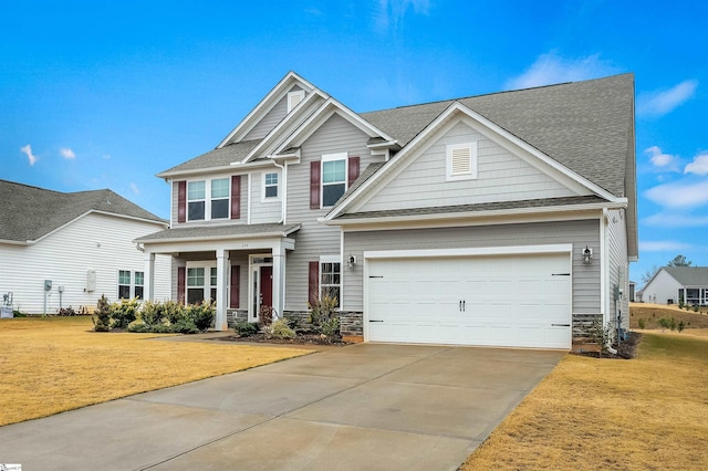 craftsman-style home featuring a front yard and a garage