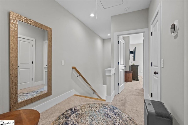 hallway featuring light colored carpet