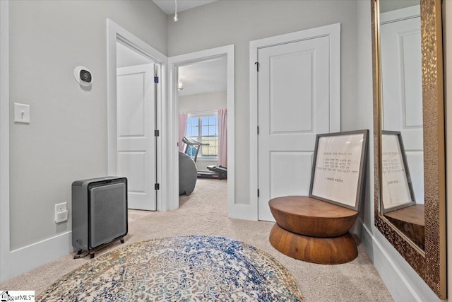 hallway featuring light carpet