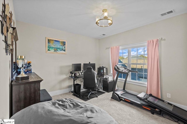 carpeted bedroom with a notable chandelier