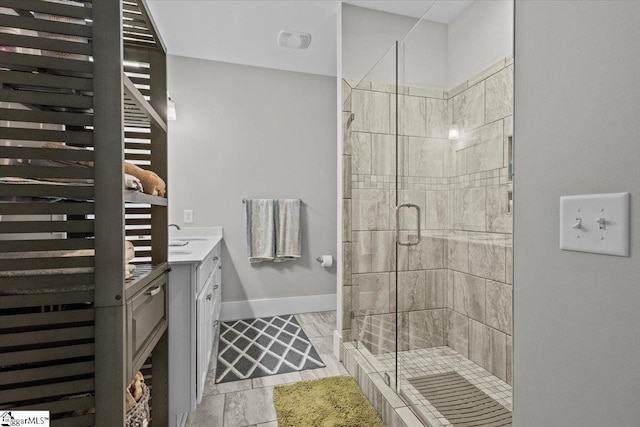 bathroom featuring tile patterned floors, vanity, and an enclosed shower