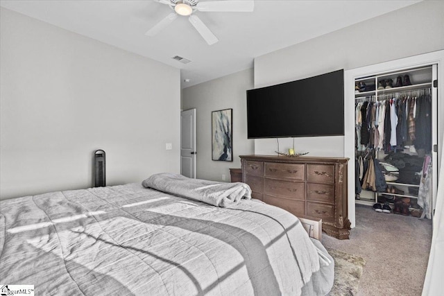 carpeted bedroom featuring ceiling fan and a closet