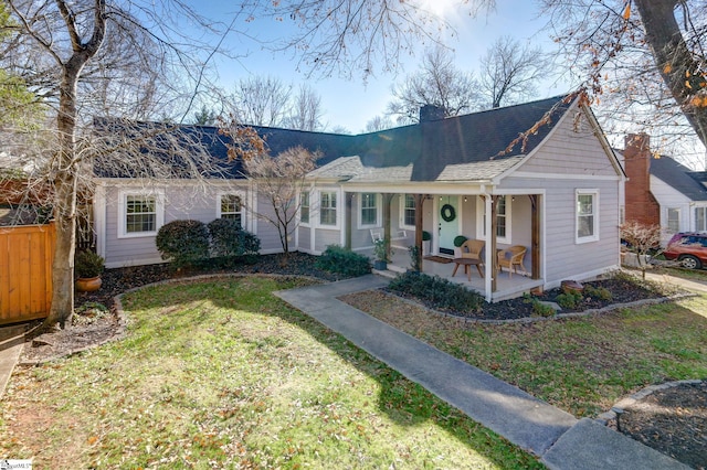 ranch-style home with a porch and a front yard