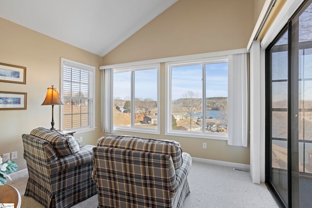 living area with light carpet and vaulted ceiling