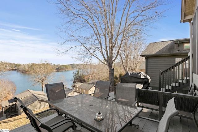 deck with a water view and a grill